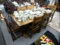 A reproduction oak refectory table on melon bulb legs and a set of six dining chairs, two with