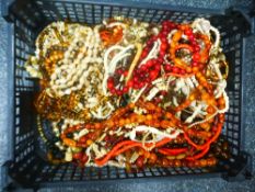 A crate of costume jewellery to include Amber style beads, bone example, etc