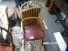 A reproduction oak stickback armchair with crinoline stretcher