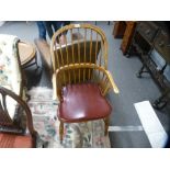 A reproduction oak stickback armchair with crinoline stretcher