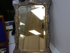 A silver framed mirror of good quality with embossed foliate design and bevelled glass. Sheffield