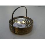 A quantity of twelve silver coasters and a holder. Marked sterling. Total weight approx 7.51ozt
