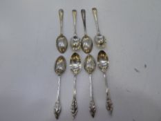 Two sets of four Edwardian and Late Victorian silver teaspoons. One with beaded embossed edge design