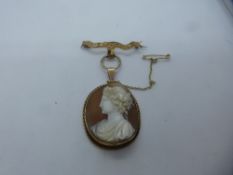 9ct yellow gold cameo pendant, hung on a yellow metal bar brooch with safety chain