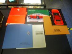 A small collection of Ferrari car brochures