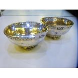 A pair of silver hammered design decorative bowls on raised ball feet, good quality and condition