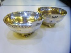 A pair of silver hammered design decorative bowls on raised ball feet, good quality and condition