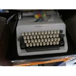 Selection of vintage typewriters, projector, etc