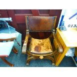 A reproduction throne style chair having leather upholstery