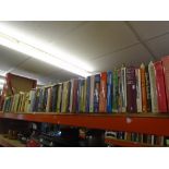 Shelf of hardback books of mixed themes