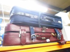 Three suitcases, two being red and one being blue