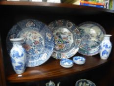 Three decorative Japanese plates, two vases and small dipping plates, with markings