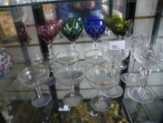 Four coloured crystal glasses with three similar cut glasses, along with 6 Babycham glasses