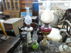 Three glass oil lamps, with shades, and brass coach lamp, marked Halewoods