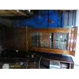 Mahogany display cabinet with glazed bookshelf over cupboards