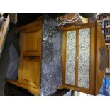 Pine washstand with marble top above cupboards and a tile back