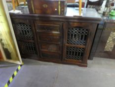 Indian style sideboard with two metal lattice doors with 4 drawers