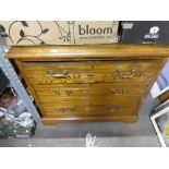 A chest of 3 drawers with brass handles