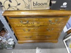 A chest of 3 drawers with brass handles