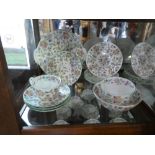 A collection of Minto tea ware depicting garden flowers, including cups, saucers, plates, sugar bowl