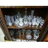 Two shelves of cut glass and crystal to include glasses, vases, jelly mould, decanters, etc