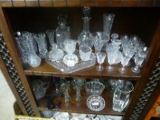 Two shelves of cut glass and crystal to include glasses, vases, jelly mould, decanters, etc