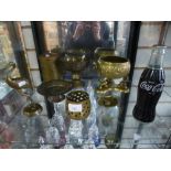 Small shelf of brassware and Coca-Cola radio