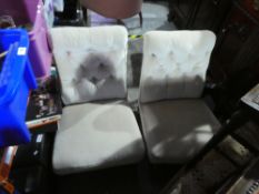 A pair of cream button backed bedroom chairs