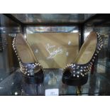 A pair of size 5 black shoes studded marked Christian Louboutin