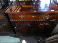A pair of mahogany sideboards, with brass hands and decorative doors