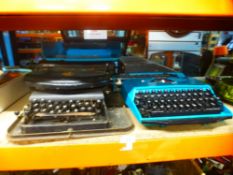 Three vintage typewriters, one being called 'The Empire'