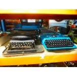 Three vintage typewriters, one being called 'The Empire'