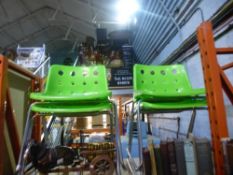 Four metal/plastic Robin Day Polo green chairs