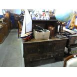 An antique carved oak sideboard having raised panel back on turned supports, 137cms