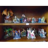 Large collection of myths and fantasy figurines including dragons, wizards, etc
