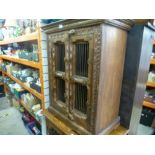 Two chunky carved wooden storage units, one with 4 drawers and an open cupboard, with lattice