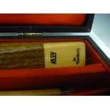 A Riley Snooker cue in a case by Dufferin, two others - one by BCE and the other by Ronnie O'