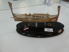 A decorative and ornate silver boat on a wooden oval stand, of pierced design hallmarked as Maltese