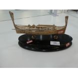 A decorative and ornate silver boat on a wooden oval stand, of pierced design hallmarked as Maltese