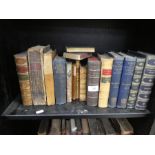 Two shelves of antique leather bound books and others