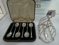 A silver Edwardian toast rack hallmarked London 1905, maker's mark Hukin & Heath, and with a set of