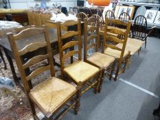 A set of four modern ladderback kitchen chairs having rush seats