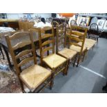 A set of four modern ladderback kitchen chairs having rush seats