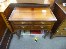 An antique lowboy having four drawers on cabriole legs, top not original, 83 cms