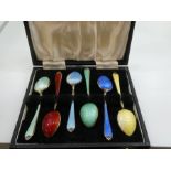 A set of six silver cased teaspoons, silver gilt and enamelled, of good quality, a nice decorative l