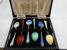 A set of six silver cased teaspoons, silver gilt and enamelled, of good quality, a nice decorative l