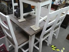 A modern white painted extending dining table and six chairs