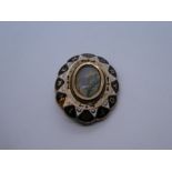 Antique oval mourning brooch, with central moonstone type stone, and words 'In Memory Of' painted ar
