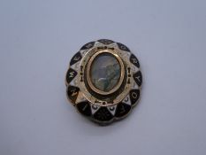 Antique oval mourning brooch, with central moonstone type stone, and words 'In Memory Of' painted ar