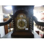 A 1930s oak chiming mantel clock with Junghaus movement, brass dial, 34 cms